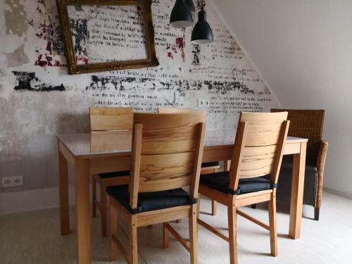 a dining room table with two chairs and a mirror at Ferienwohnung Gebauer in Hornbach