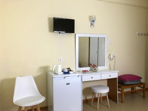 a bathroom with a white vanity and a mirror at Laios Hotel (Adults Only) in Limenas