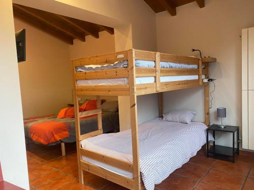 a bedroom with two bunk beds in a room at Baketxe Baserria in Ziortza-Bolibar