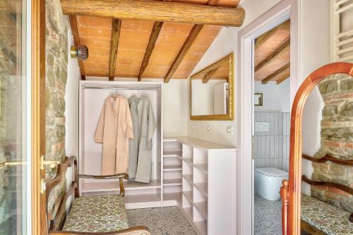 a small bathroom with white walls and a wooden ceiling at Villa Maria in Monte San Savino