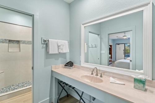 a bathroom with a sink and a mirror at Beachside Inn in Destin