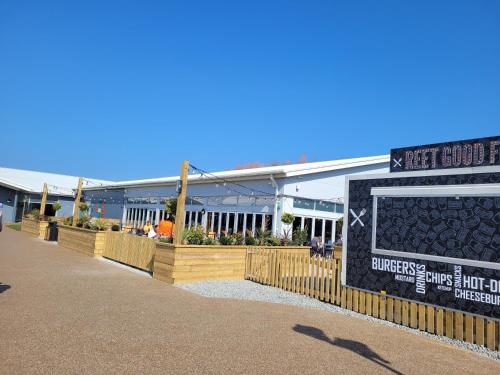 a sign on a fence in front of a building at LUXURY CARAVAN 10 mins TO BEACH in Hull