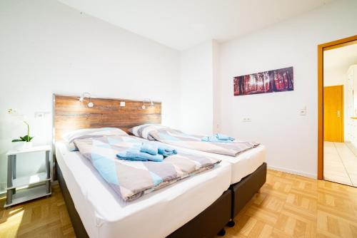 a bedroom with a large bed with a wooden headboard at Ferienwohnung Bernd in Lathen