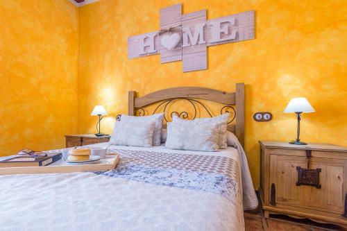 a bedroom with a bed and two tables with lamps at El Mirador De Ruidera in Ruidera