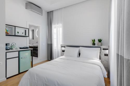 Ένα ή περισσότερα κρεβάτια σε δωμάτιο στο Times Elegant Rooms