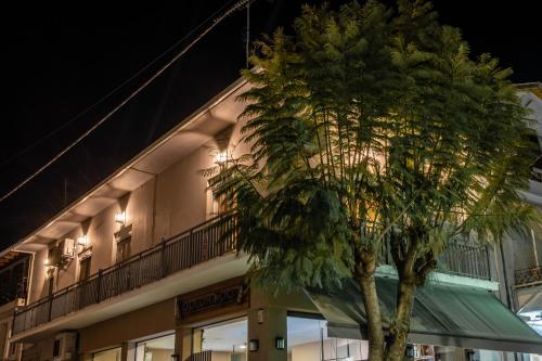 a tree in front of a building at night at Agios Pavlos Corner Vacation House Zakinthos in Zakynthos Town