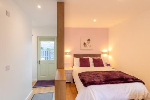 a bedroom with a bed and a window at Allt Mor Rentals - Chalet with hot tub, And Studio Apartment no hot tub in Roybridge