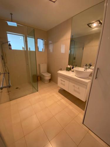a bathroom with a sink and a shower and a toilet at Our Little Tootgarook, 2 min walk to the beach in Tootgarook