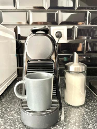 a coffee maker with a cup on a kitchen counter at Luxury apartment in center Cascais in Cascais