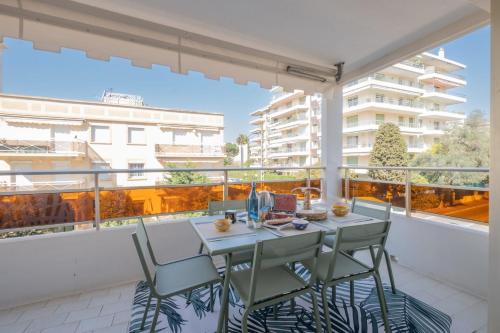 un balcon avec une table et des chaises sur un balcon dans l'établissement Stylish 2-Br Apartment Steps from the Croisette, à Cannes