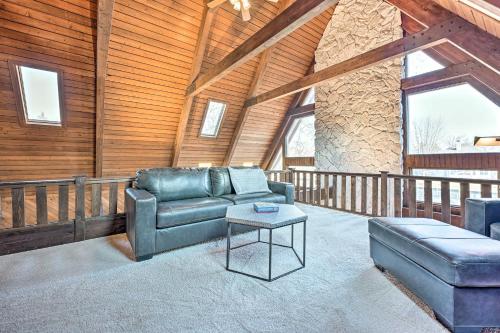 a living room with a couch and a table at Spacious Syracuse Getaway with Waterfront Deck! in Syracuse