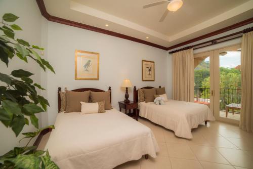 a bedroom with two beds and a balcony at 3 bedroom Bella Vista 2D close to pool by Stay in CR in Herradura