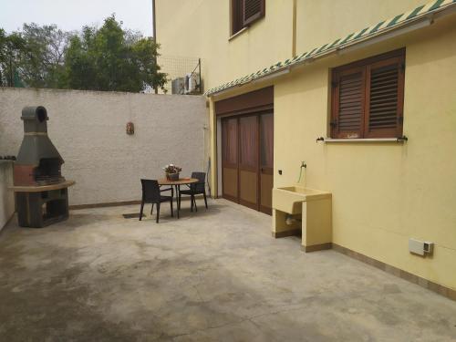 a patio with a table and chairs next to a building at Oro&Mattia's House in Trapani