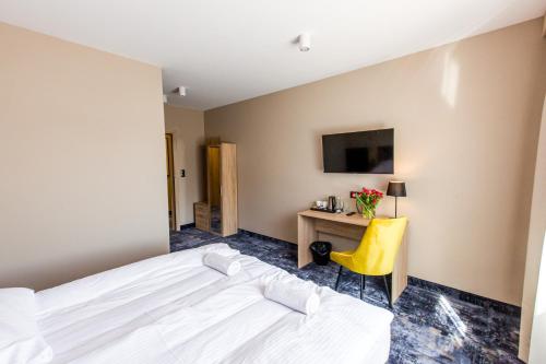 Ένα ή περισσότερα κρεβάτια σε δωμάτιο στο Hotel Zodiak