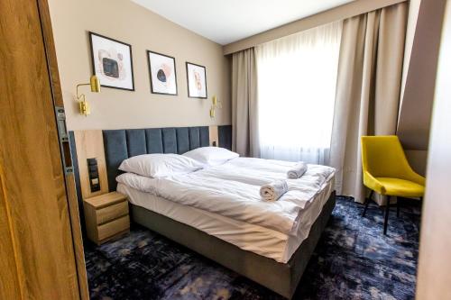Ένα ή περισσότερα κρεβάτια σε δωμάτιο στο Hotel Zodiak