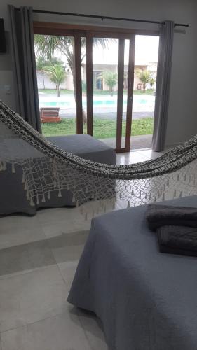 Ένα ή περισσότερα κρεβάτια σε δωμάτιο στο Pousada Casa du Soleil Camocim