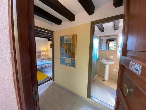 a room with a bathroom with a sink and a mirror at Villa Paradisino in Orbetello