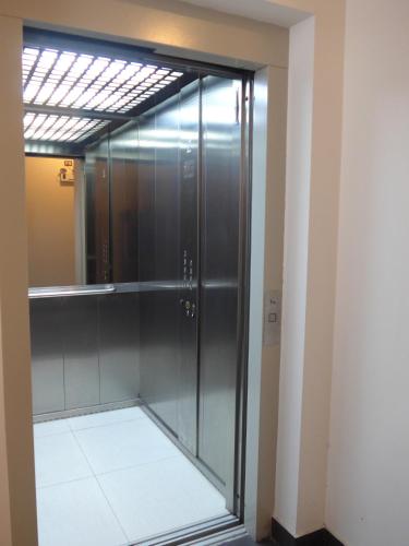 a glass shower in a room with a mirror at Spacious Apartment in Miraflores in Lima