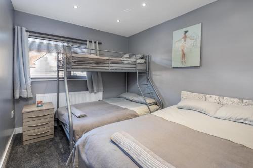a bedroom with two bunk beds and a window at Annandale House Hartlepool in Hartlepool