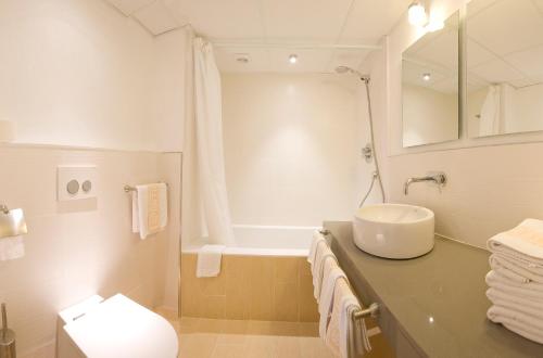 a bathroom with a sink and a bath tub at Playa Bella Apartments in San Antonio Bay