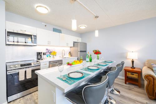 a kitchen with a long long table with chairs at Ocean & Diamond Head Views - Near Beach - Parking! in Honolulu