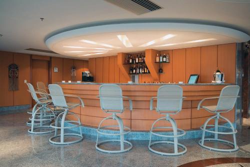 a bar with chairs lined up in front of it at Windsor Barra Hotel in Rio de Janeiro