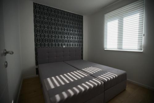 Postel nebo postele na pokoji v ubytování Sonia Apartman