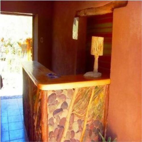 a wooden counter with a lamp on top of it at Loma Sanchez in San Pedro de Atacama