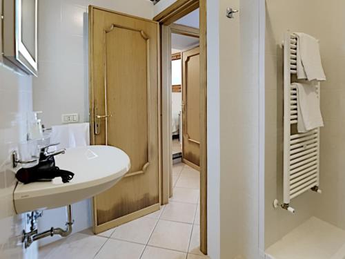 een witte badkamer met een wastafel en een douche bij The Hidden Garden in Ravello