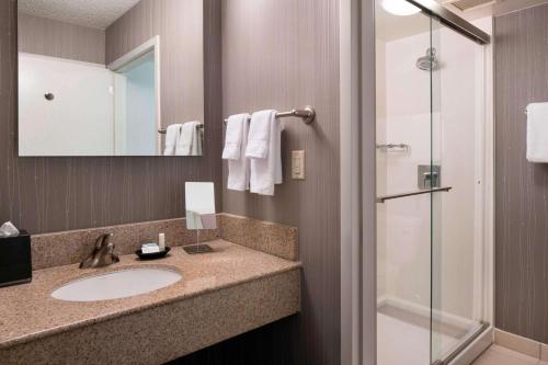a bathroom with a sink and a shower at Sonesta Select Los Angeles Torrance South Bay in Torrance