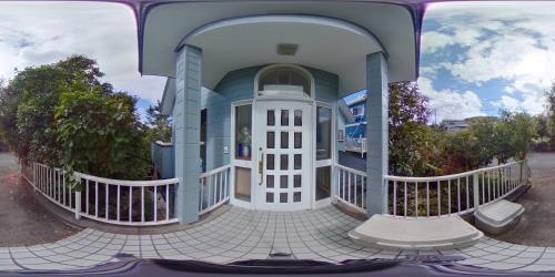 a front view of a house with a porch at Holiday Home Apple in Ito