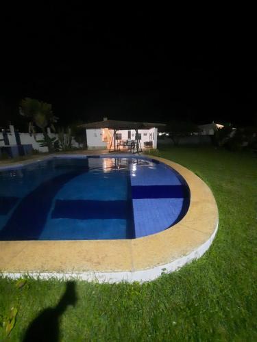 a swimming pool in a yard at night at CASA ESTRELA e SOL in Barra de Jacuípe