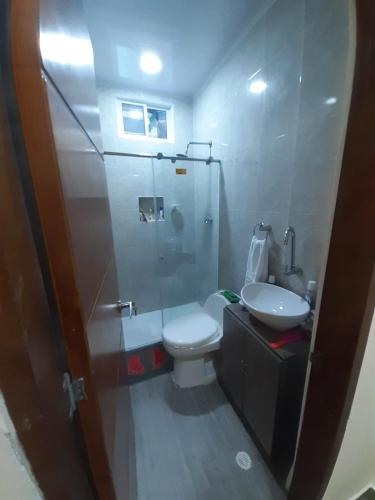 a bathroom with a shower and a toilet and a sink at Casa Hotel Alborada in San Antero