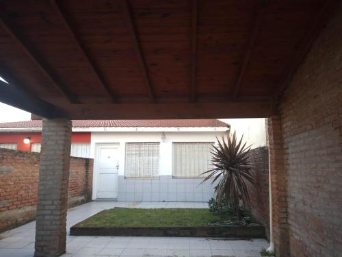 a house with a garage and a brick wall at LA CASA DEL MAR in Santa Clara del Mar