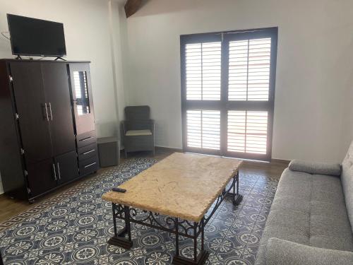a living room with a couch and a table at Villa Serena Centro Historico in Mazatlán
