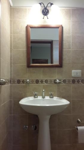 a bathroom with a sink and a mirror at DEL INFINITO in Capilla del Monte