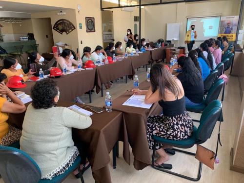 a group of people sitting at tables in a room at Hotel Oro Inn in Lima