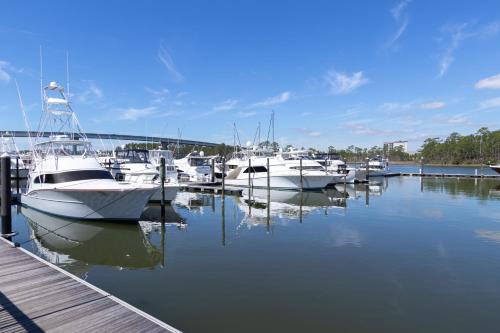 a bunch of boats are docked in a marina at Two-Bedroom Apartment in Orange Beach