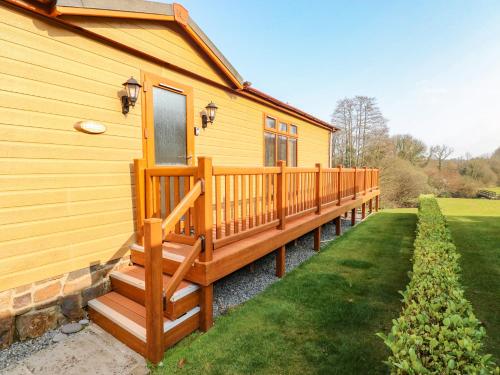 a house with a large deck on the side of it at Jules 79 in Narberth