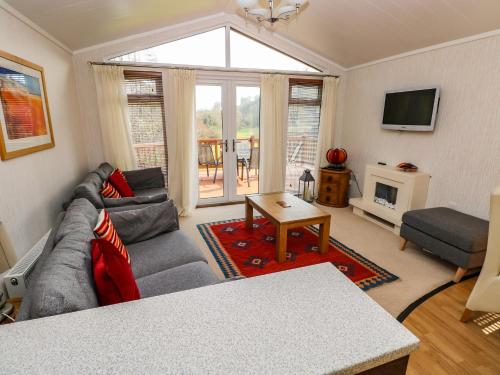 a living room with a couch and a tv at Jules 79 in Narberth