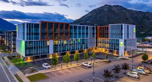 a rendering of a building with a mountain in the background at Holiday Inn Queenstown Remarkables Park in Queenstown