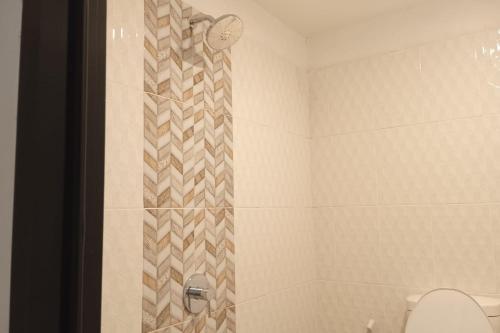 a bathroom with a shower with a toilet at Gorland Hostel near GOR Satria Purwokerto Mitra RedDoorz in Purwokerto