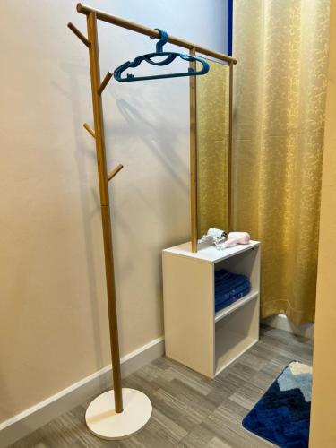 a floor lamp in a room with a mirror at 243Hotel in Ta Phraya