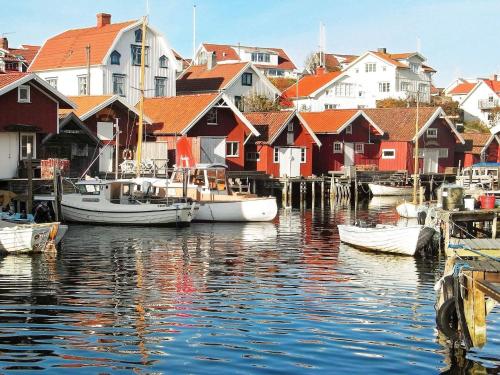 a group of boats docked in a harbor with houses at 2 person holiday home in KUNGSHAMN-By Traum in Kungshamn