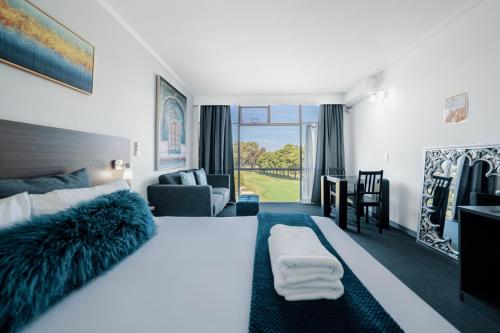 a bedroom with a bed and a living room at The Select Inn Ryde in Sydney