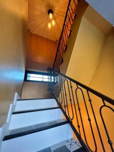 a set of stairs in a building with a ceiling at 243Hotel in Ta Phraya