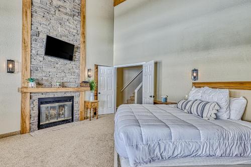 a bedroom with a large bed and a fireplace at Legacy Villa in Brian Head