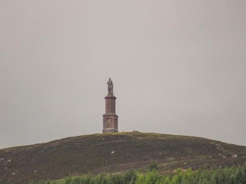 a lighthouse on top of a grassy hill at The Steading in Rogart