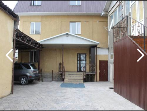 a car parked in front of a house at Adilet in Bishkek