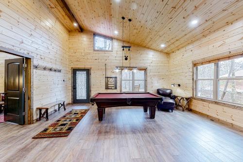 a ping pong table in a room with wooden walls at Cozy Bear Cabin #1 in Sautee Nacoochee